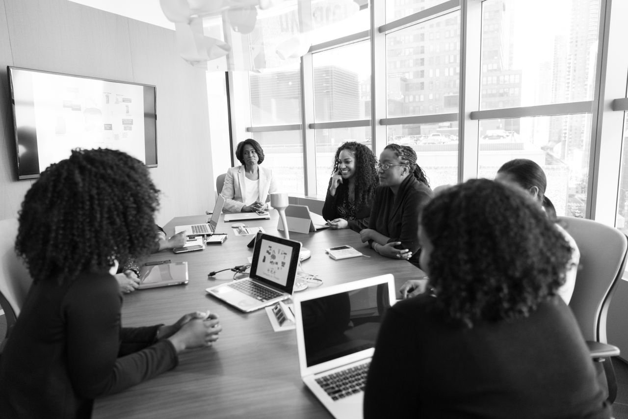 About Black women collaborating in a modern office meeting. Engaging and productive work environment.