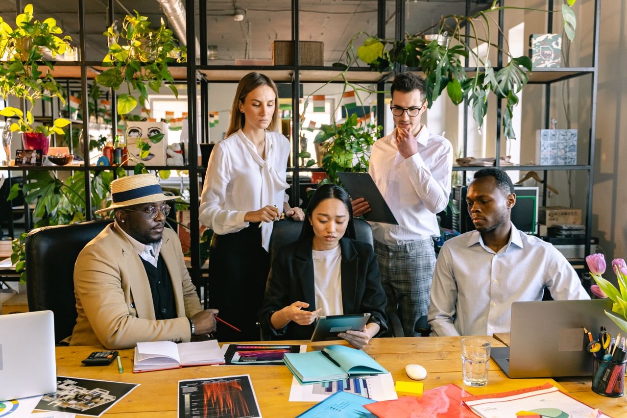About A diverse team of professionals collaborating on a project in a lively office setting.